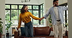 Funny, couple and dance in home with energy, freedom and laugh for anniversary celebration. Living room, man and woman moving to music with love, happiness and holding hands for romance together