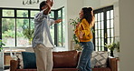 Smile, dancing and couple in home with music, fun or bonding together in living room with energy. Happy, love and man with woman for moving to playlist, album or radio for entertainment in apartment.