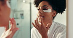 Home, skincare and woman with eye patch, grooming and shine of lips with lipgloss, mirror or beauty. Reflection, African person and routine for anti aging, makeup and cosmetics for skin in house