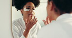 Mirror, skincare and woman with eye patch, grooming or shine of lips with lipgloss, beauty and home. Reflection, African person and routine for anti aging, makeup and cosmetics for skin in house