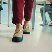 Feet, person and teacher walking in classroom to monitor students, exam ...