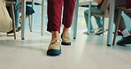 Feet, person and teacher walking in classroom to monitor students, exam supervision and protocol. Legs, lecturer and Invigilation of assessment, prevent cheating and maintain order of time management