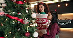 Christmas tree, ornament and mom with child in home for holiday, festive tradition and bonding. Family, love and happy mother and girl with bauble for celebration, December and xmas aesthetic