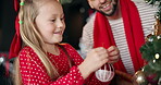 Father, kid and tree with decoration on Christmas, festive celebration and holiday tradition. Smile, man and child help with sparkle ornaments, preparation and family bonding for xmas season in home