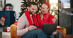 Christmas, credit card and laptop with couple on sofa in living room of home for online shopping. Computer, ecommerce and gift search with happy people in apartment for December or festive purchase