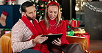 Smile, couple and phone on Christmas at house for social media, browsing internet and gift search. People, talking and mobile for present decision, online shopping and ecommerce for  festive season