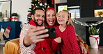 Christmas, hug and selfie with family in living room of home together for December celebration. Festive, photograph or social media with dad, girl and mom embracing in apartment for holiday memories