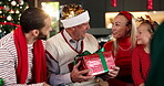Family, giving and grandfather gift on Christmas, holiday celebration and bonding together. People, surprise and senior man with present, xmas party and gratitude for reunion of festive event in home