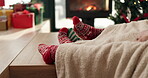Christmas, playful socks and feet of family in home for vacation break, cozy festive and bonding. Winter, blanket and people relax together in living room for xmas holiday, connection and comfortable