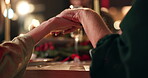 Holding hands, people and Christmas party with prayer for worship, gratitude or thanks to God for the food. Tradition, community or family at dinner, saying grace or praise for holiday celebration