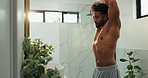 Man, mirror and stretching in bathroom for fitness progress, muscle growth and workout results. Male person, reflection or inspection of body transformation, grooming routine or getting ready in home