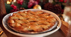Christmas, festive and tradition with tart in home for baking, cooking or dessert from above. Apple pie, cake or food on dining room table in apartment for celebration, holidays and winter vacation
