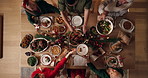 Dishing, people and christmas dinner in home for festive celebration, event or party together. Food, top view and family in dining room for sharing gourmet meal, feast or supper for xmas in house.