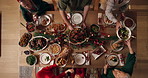 Food, family and christmas dinner in home for festive celebration, event or party together. Dishing, top view and people in dining room for carving meat with gourmet meal, feast or supper for xmas.