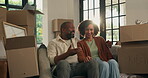 Talking, moving and relax with couple in new home for property, planning or relocation. Mortgage discussion, real estate and renting with man and woman in living room for love and house purchase