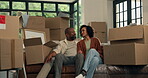 Talking, moving and sofa with couple in new home for property, planning or relocation. Mortgage discussion, real estate and renting with man and woman in living room for love and house purchase