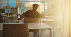 Class, sunset and man at university for studying with education, test or exam for learning. Knowledge, male person and back of student with college assessment or assignment in lecture room at campus.