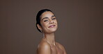Beauty, skincare and smile with face of woman in studio for shine, self care and hydration. Aesthetic, dermatology and natural glow with model on brown background space for collagen and grooming