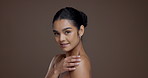 Shoulder, beauty and smile with face of woman in studio for skincare, body care and hydration. Aesthetic, dermatology and natural glow with female model on brown background space for collagen