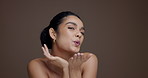 Funny face, skincare and woman blow kiss on studio background with space for beauty. Portrait, cosmetics and excited female model with silly pout, playful and natural dermatology for self care