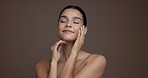 Touch face, skincare and woman with glow, natural beauty and aesthetic on studio background space. Portrait, smile and model with facial cosmetics for collagen treatment, results or skin wellness