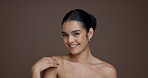 Chest, skincare and smile with face of woman in studio for beauty, body care and hydration. Aesthetic, dermatology and natural glow with model on brown background space for collagen and grooming