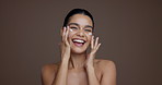 Girl, face and cream application in studio with smile, playful and laugh for beauty by background. Happy woman, portrait and space for dermatology product, results or moisturizer lotion in Mexico