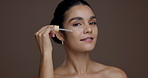 Girl, dropper and face for skincare in studio, liquid or hyaluronic acid for beauty by background. Woman, oil and smile for dermatology, cosmetics or space with results, benefits or serum in Peru