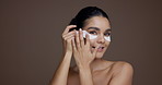 Skincare, face or woman with eye mask in studio for hydration, anti aging or beauty treatment. Depuff, mockup or girl with product application for collagen, skin glow or self care on brown background