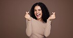 Face, smile and woman with finger heart, confident and excited with symbol for celebration and like. Studio background, mockup space and person with love sign, kiss and gesture for valentines day