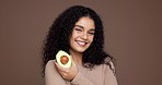Avocado, happy woman and face in studio for skin care, brown background and hydration. Beauty, fruit and female model with omega 3, collagen and natural treatment with organic facial cosmetics