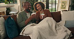 African couple, laughing and relax with coffee on sofa for bonding, funny story and cozy together. Love, mature people and happy with blanket in house for weekend break, conversation and connection