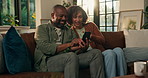 Mature African couple, phone and relax on sofa, story and video with web post in living room. Woman, man and smartphone on couch with mobile app, bonding or point with social network at apartment