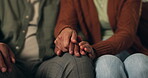 Couple, relax and holding hands in home for support, comfort and love in marriage. Man, woman and touch in living room for care, relationship stability and understanding partner with appreciation