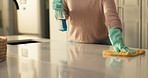 Hands, cloth and spray for cleaning, kitchen counter and disinfectant for germs in house. Person, gloves and bottle with liquid for bacteria, hygiene and routine for dust, shine and rag at apartment