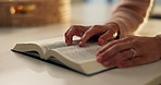 Hands, reading and bible study in home, faith and scripture review for spiritual guide with information. Person, book and knowledge for Christian religion, story and holy literature for God at house
