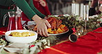 Family, hands or dining table with chicken for christmas dinner, cuisine or serving in home. People, food or roast with vegetables, gourmet dish or meal for thanksgiving celebration or lunch in house