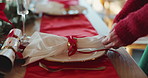 Christmas, setting and hands of woman by table for lunch celebration, holiday party and event. December, dining room and person with napkin, ribbon and plate for tradition, festive season and xmas
