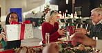 Excited, Christmas gift and woman with big family for for vacation, bonding and celebration. December, holiday or festive surprise with people, senior parents and smile with social gathering in home