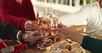 Champagne, cheers and people in home for christmas celebration, party or gathering together. Happy, toast and family in dining room with sparkling wine for xmas event in festive season at house.