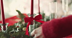 Christmas, decoration and hands of woman with ribbon on candle for lunch, dinner and holiday celebration. December, dining table and person with bow for tradition, festive season and xmas event