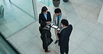 Top view, tablet and group of business people planning in office lobby for investment banking. Above, technology and team collaboration for finance, brainstorming or meeting with corporate discussion
