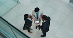 Above, tablet and group of business people planning in office lobby for investment banking. Top view, technology and team collaboration for finance, brainstorming or meeting with corporate discussion