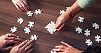 Puzzle, hands and business people in office for teamwork, solidarity and synergy for cooperation. Collaboration, top view and corporate employees with jigsaw for problem solving, challenge or unity.