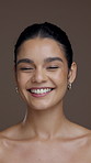 Happy, beauty and face of woman in studio for skincare results, cosmetics and facial treatment. Salon, dermatology and portrait of person smile for natural glow, shine or wellness on brown background