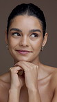 Thinking, beauty and face of woman in studio for skincare, cosmetics and facial treatment. Salon, dermatology and portrait of person smile for natural glow, shine or wellness on brown background
