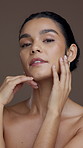 Skincare, beauty and face of woman in studio with glowing skin, hydration and collagen treatment. Clean, person and happy with cosmetics on brown background for dermatology, self care and wellness