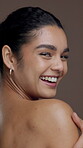 Body care, beauty and face of woman in studio with glowing skin, hydration and cosmetics treatment. Clean, person and happy with skincare on brown background for dermatology and chemical peel results