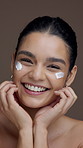 Skincare, studio and face of woman with cream for moisturizing, anti aging and hydration. Dermatology, brown background and portrait of person with lotion cosmetics for beauty, benefits and health