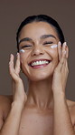 Skincare, studio and face of happy woman with cream for moisturizing, anti aging and hydration. Dermatology, salon and portrait of person with lotion for beauty, glow and health on brown background